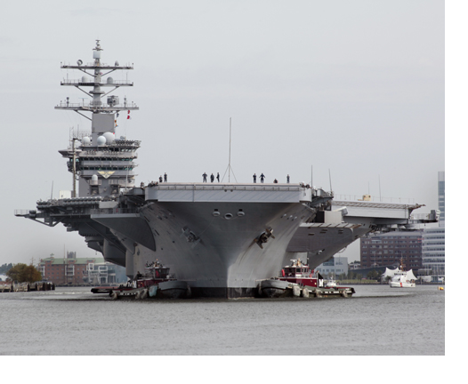 (100908-D-4748B-024) PORTSMOUTH, Va.--Tugboats guide the Nimitz-class aircraft carrier USS Dwight D. Eisenhower (CVN 69) on the Elizabeth River. Shipyard personnel at Norfolk Naval Shipyard completed repairs to the USS Dwight D. Eisenhower's catapult launch system March 21 as a part of the during the aircraft carrier's Planned Incremental Availability.